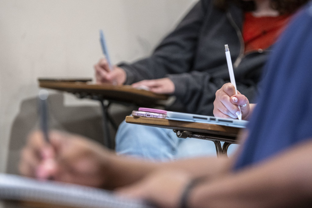 academics: students writing notes in a classroom