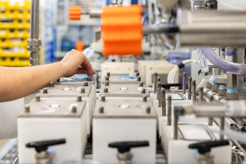 research: student conducting research in a lab
